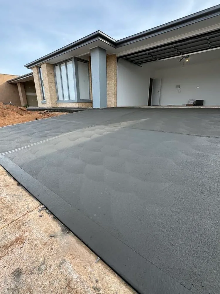 Newly poured charcoal concrete driveway at a new home