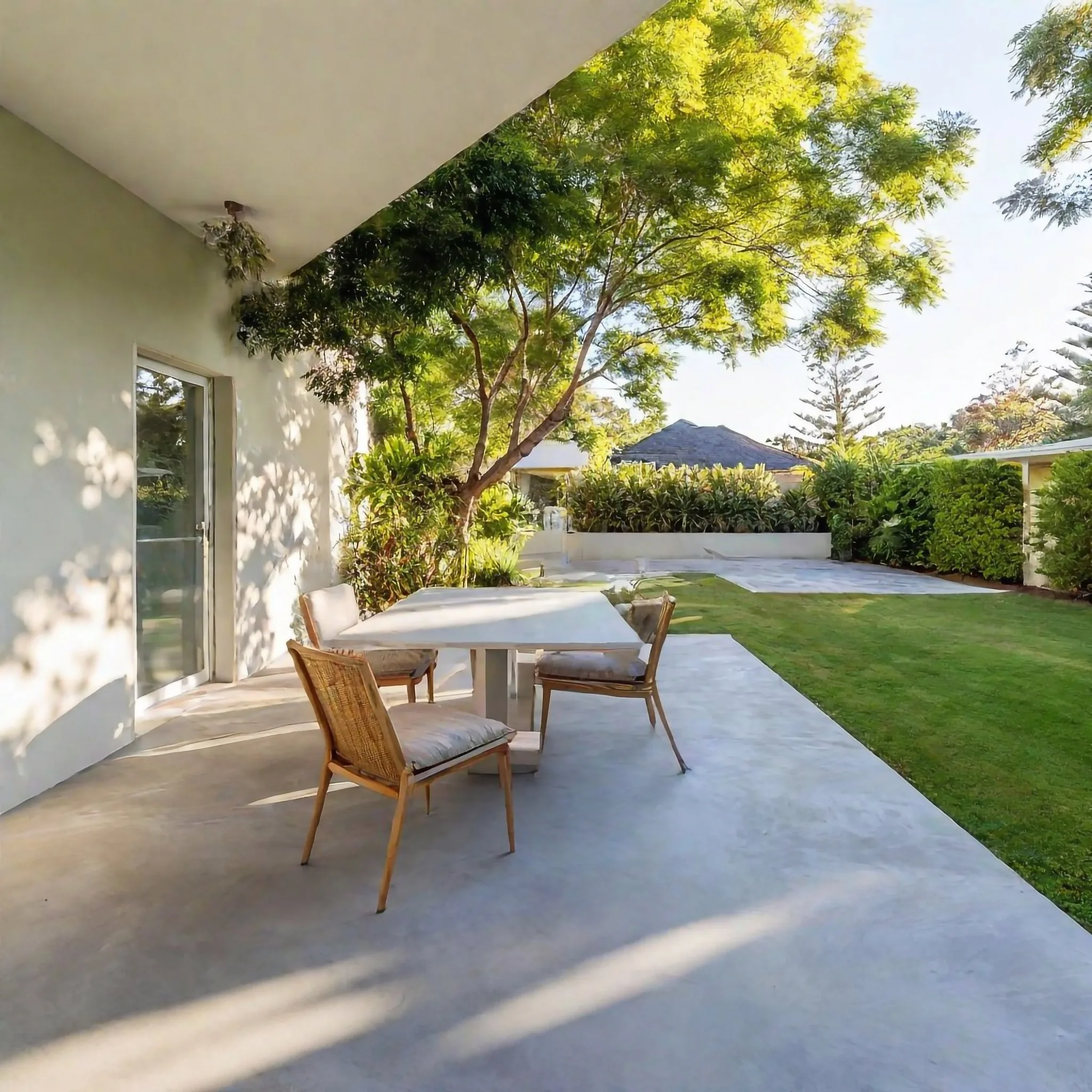 Concrete patio with outdoor setting under a covered alfresco
