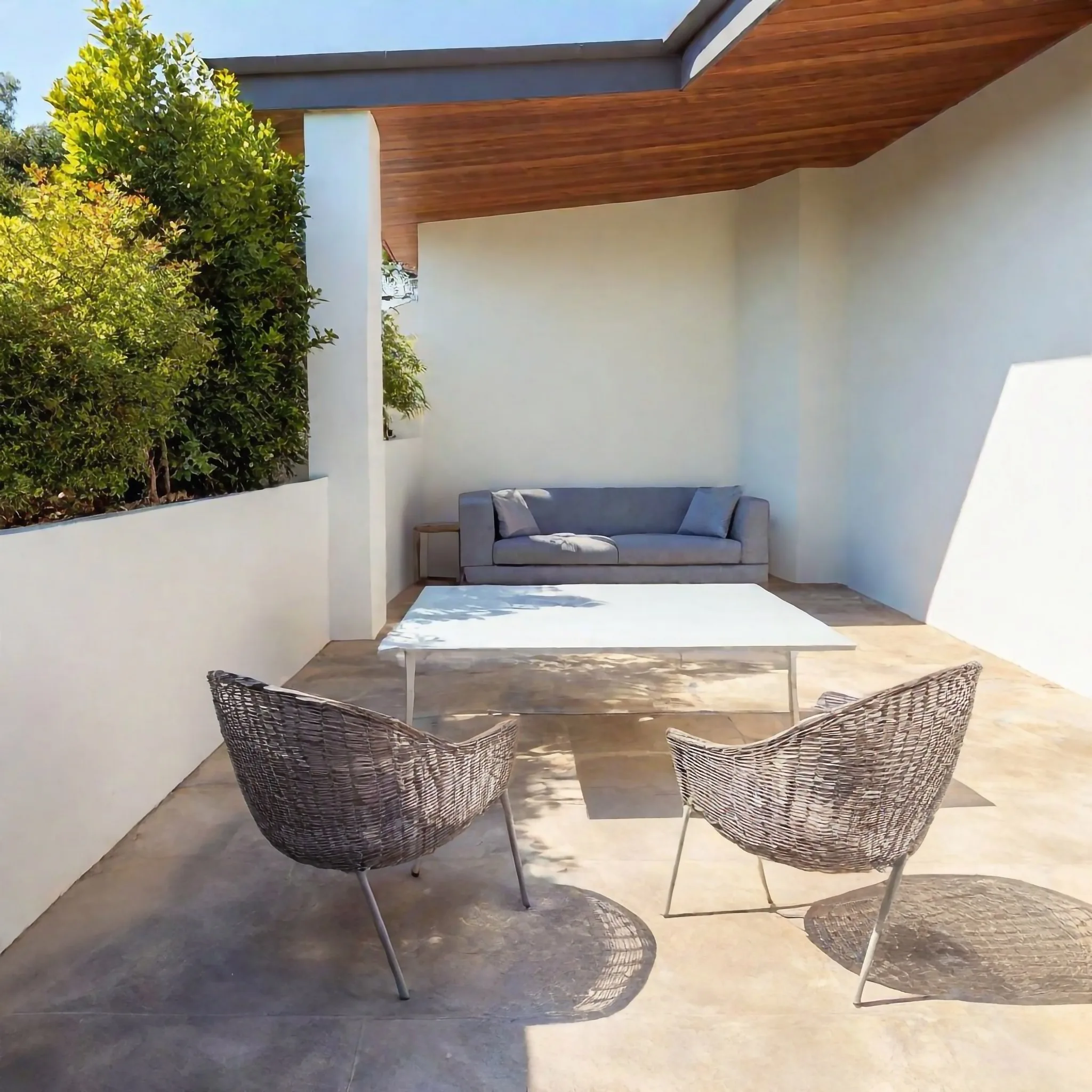 Concrete patio with lounge and outdoor chairs