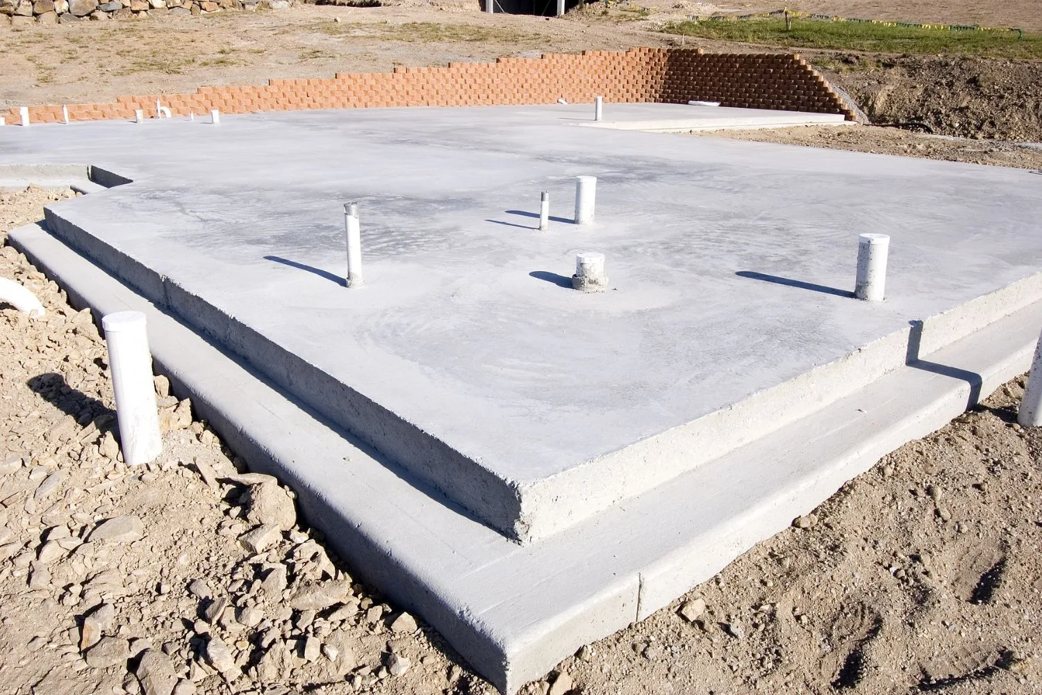 Concrete slab with plumbing set-outs on a building site