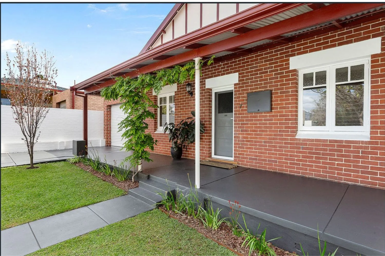 Concrete porch and front path at a brick home