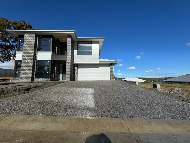 Exposed aggregate driveway poured for a two-storey home