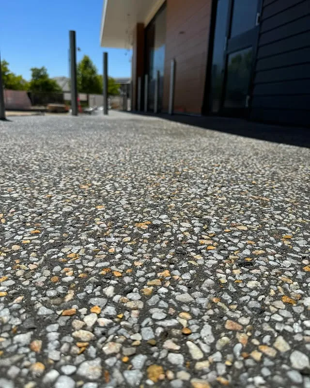 Exposed aggregate path in front of a modern home