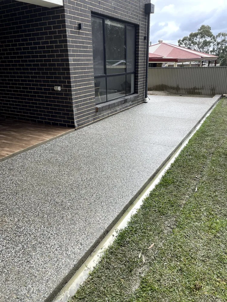 Exposed aggregate path poured beside a house