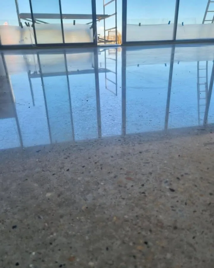 Honed concrete floor slab inside a glass-fronted building