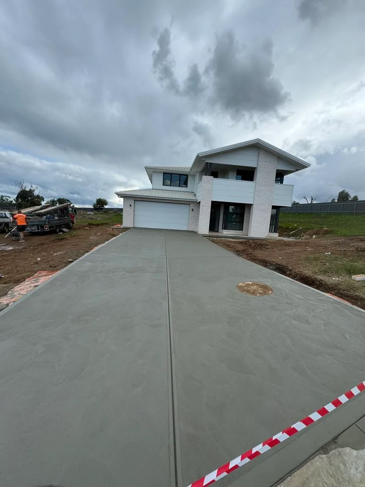 Plain concrete driveway poured for a two-storey new build